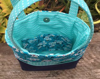 Inside the teal and navy Stand Up Clutch - Andrie Designs