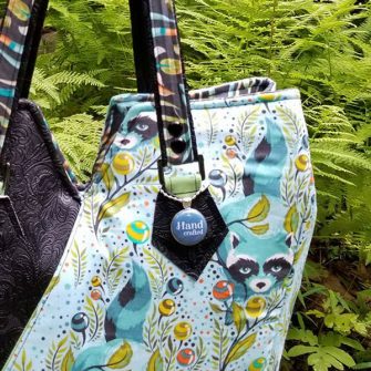 Navy swing tag on a beautiful handmade bag - Andrie Adornments