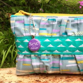 Purple swing tag on a gorgeous Gather Me Up Clutch - Andrie Adornments