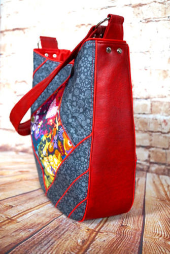 Side view of the Alison-Glass-themed with red piping Feature Me Everyday Tote - Andrie Designs