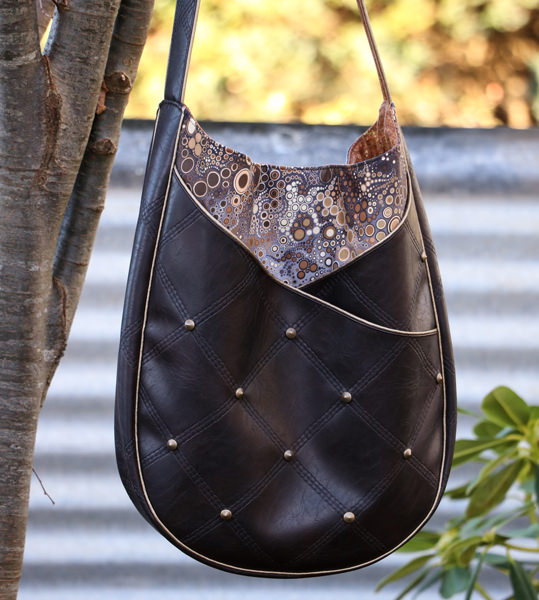 Leather and gold piping make up this S & S Tote - Andrie Designs