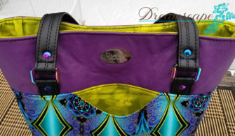 Outer slip pocket and iridescent hardware help make this Classic Market Tote pop - Andrie Designs