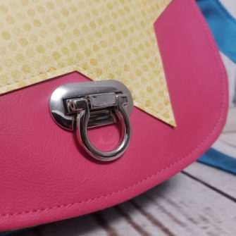 Close up of the turn lock on the bright 'star' motif That Flap Saddlebag - Andrie Designs