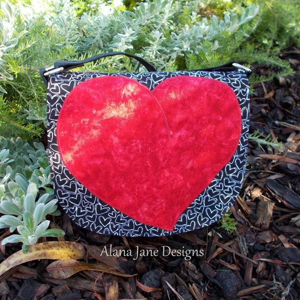 Deep textured red for this 'heart' motif That Flap Saddlebag - Andrie Designs