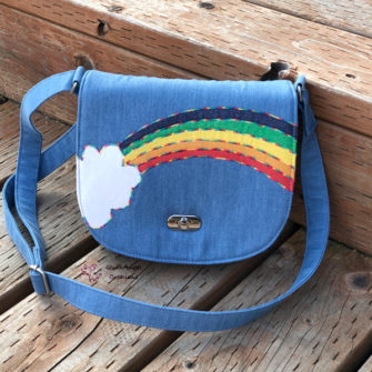 It's rainbow all the way for this 'rainbow' motif That Flap Saddlebag - Andrie Designs