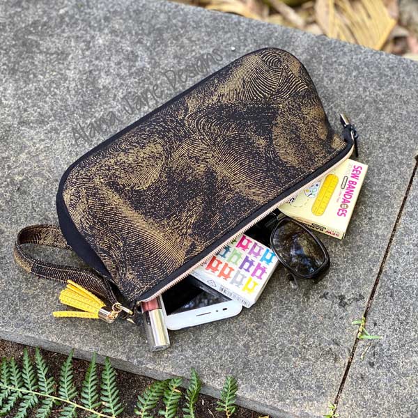 Black and gold V Pouch in use - Andrie Designs