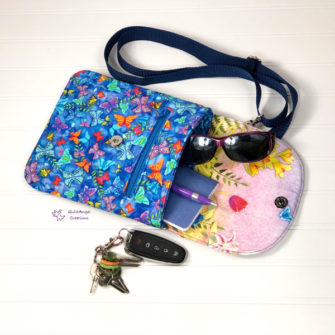Open view of the butterflies-themed Polly Cross Body Pouch - Andrie Designs