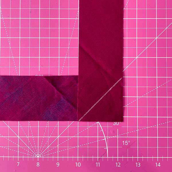 Lay 2 strips RS together at corner and draw line - Triangle folded in half - How to Cut and Join Bias Strips - Andrie Designs