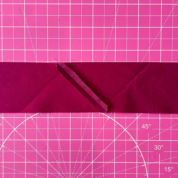 Seam Pressed open - Triangle folded in half - How to Cut and Join Bias Strips - Andrie Designs